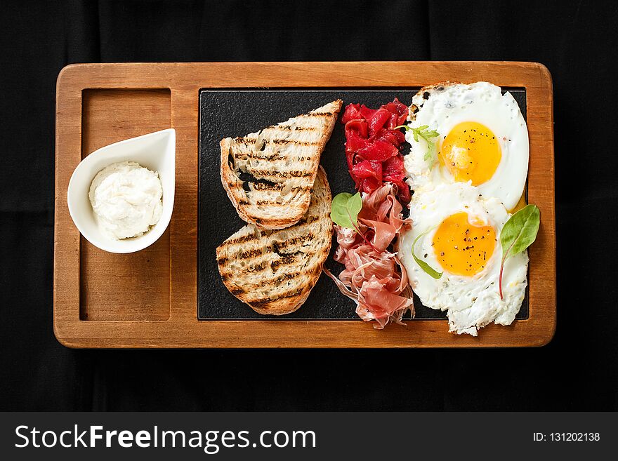 Top view breakfast eggs and toast jamon and cheese. American breakfast concept. Food on wooden board. Delicious lunch. Serving dishes concept. Restaurant food concept, healthy food.