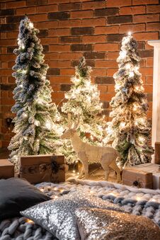 Loft Apartments, Brick Wall With Candles And Christmas Tree Wreath. Pillows And A Blanket On The Floor Stock Image