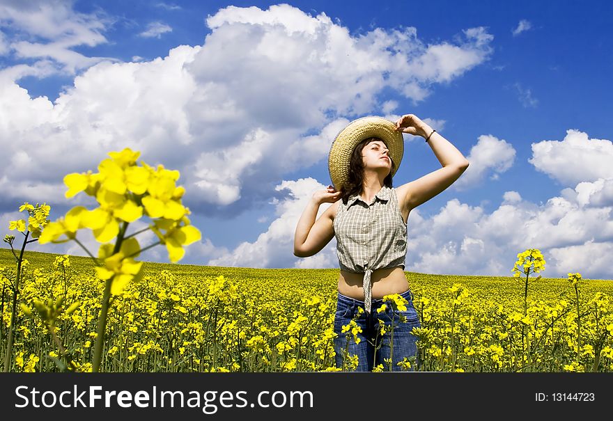 Young girl enjoying summer time on yellow field