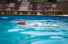 Vacation In A Tourist Resort. Woman Swims In The Pool. Royalty Free Stock Photos