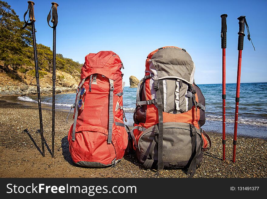 Backpacks on the beach of the Mediterranean Sea in a hike