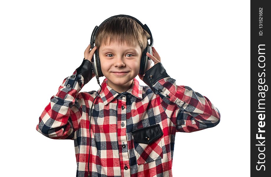 Portrait of a little boy listening to music in headphones on a white background