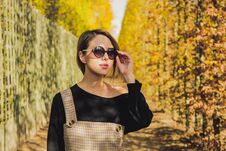 Girl In Sunglasses In Autumn Season Park Royalty Free Stock Image