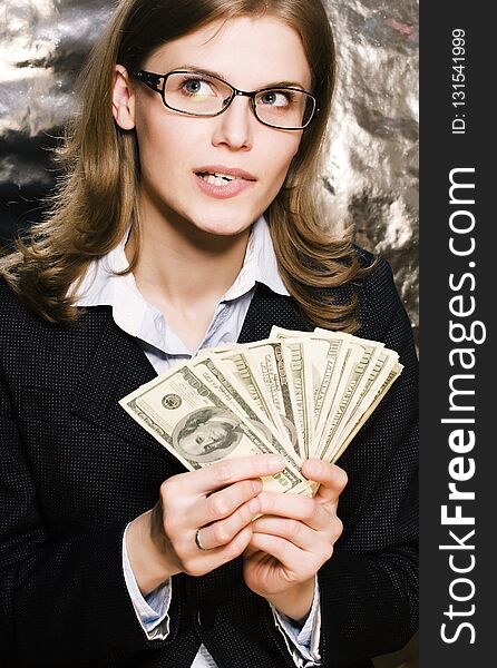 Pretty young brunette real modern woman in glasses with money ca