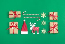 Christmas Composition. Christmas Decoration Gifts, , Santa Claus Hat , Candy, Snowflakes On Green Background. Stock Photos Christmas Composition. Christmas Decoration Gifts, , Santa Claus Hat , Candy, Snowflakes On Green Background. Stock Photos