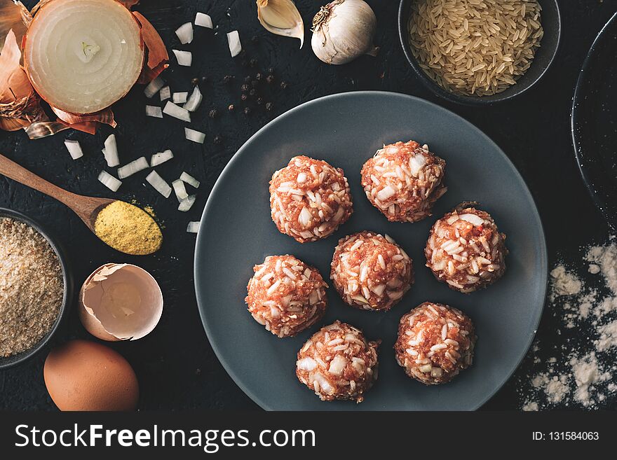 Traditional lunch recipe. Pork meatballs on top of the dark background. Food preparation. Top view.