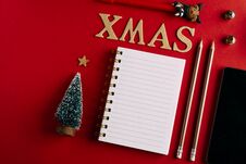 Christmas Shopping List And Mobile Phone, Holiday Planning Red Background, Notebook And Christmas Decoration Stock Photos