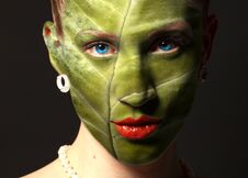 Woman Face With Leaf Texture And Blue Eyes. Ecology Concept. Stock Photos