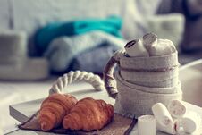 Cozy Winter Still Life, Consist Of, Cup Of Coffee, Marshmallow, Croissants And Fur Shoes With Sweaters In The Home Interior Royalty Free Stock Photo Cozy Winter Still Life, Consist Of, Cup Of Coffee, Marshmallow, Croissants And Fur Shoes With Sweaters In The Home Interior Royalty Free Stock Photo