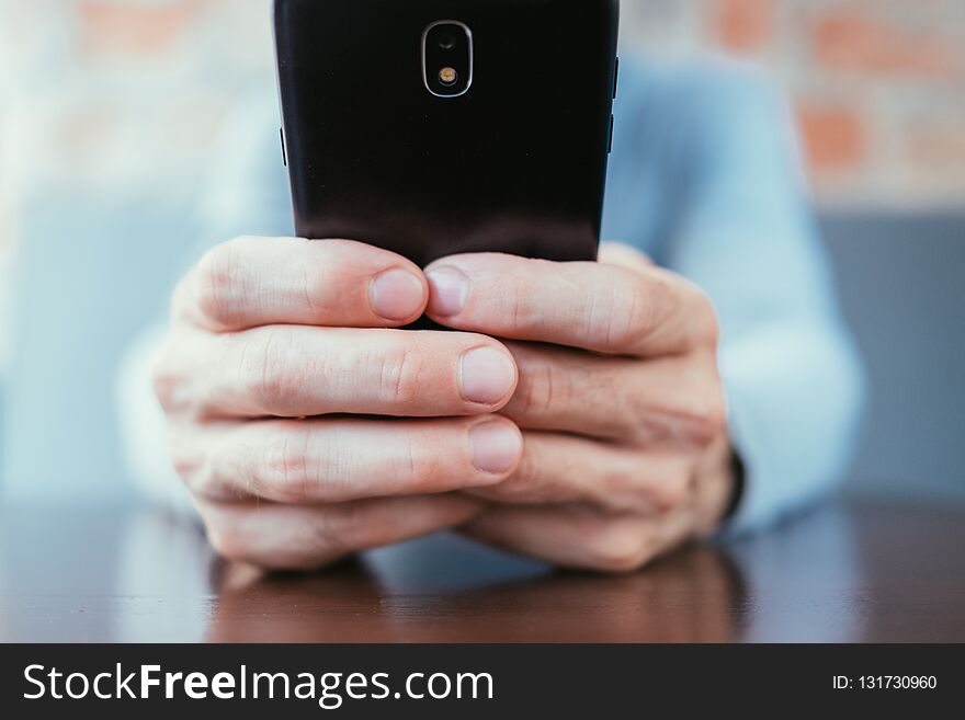 Communication messaging and texting. social networking and mobile technology. man hands holding phone. Communication messaging and texting. social networking and mobile technology. man hands holding phone