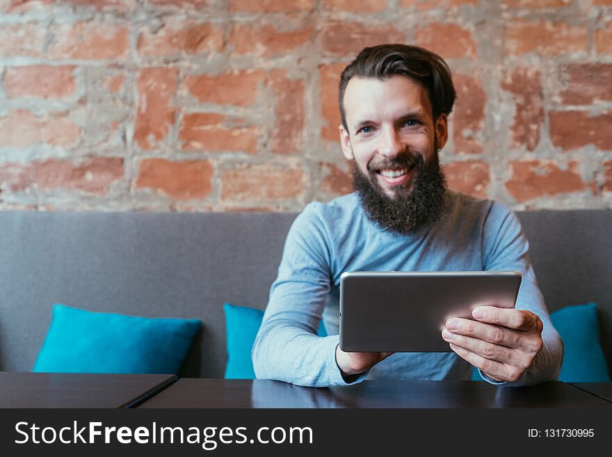 Mobile devices addiction. man holding tablet. social networks and idle leisure concept. Mobile devices addiction. man holding tablet. social networks and idle leisure concept