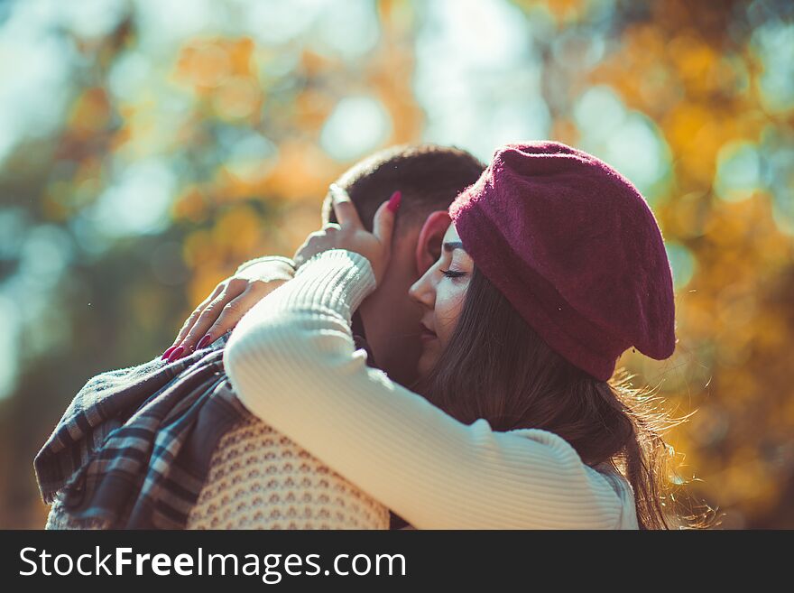 Sweet couple is outdoors in nature, looking peacefully and hugging