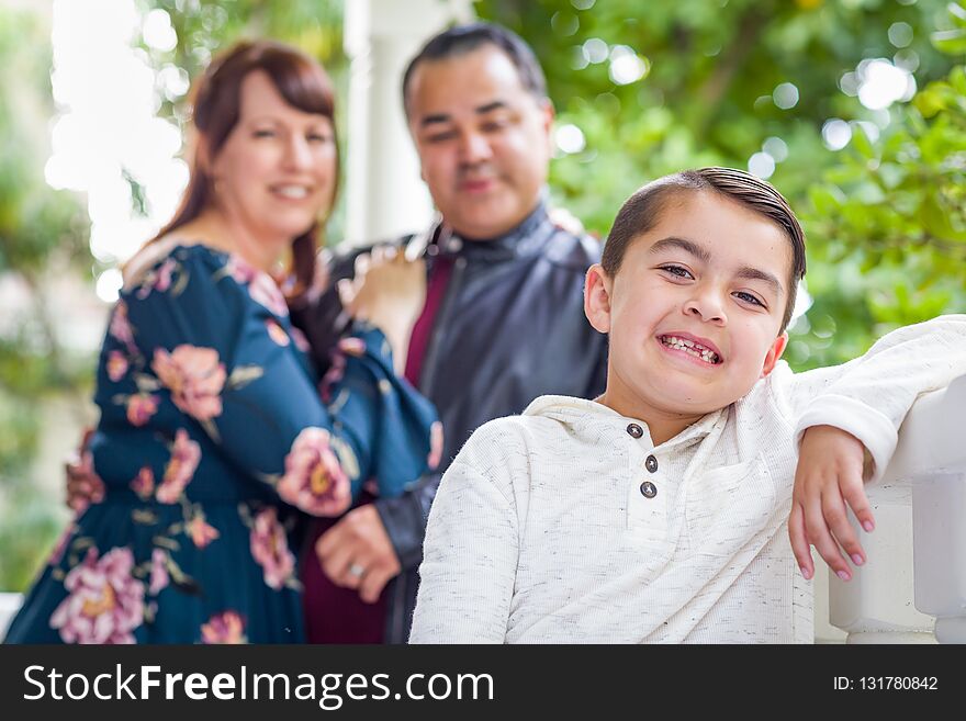 Portrait of Mixed Race Couple Standing Behind Young Son