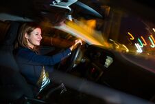 Driving A Car At Night - Pretty, Young Woman Driving Her Car Royalty Free Stock Photography