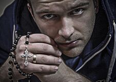 A Thoughtful Man With A Rosary Royalty Free Stock Image