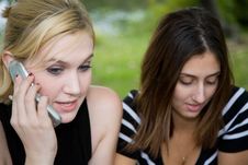 Friends On Cell Phone Together (Beautiful Young Blonde And Brune Royalty Free Stock Photography Friends On Cell Phone Together (Beautiful Young Blonde And Brune Royalty Free Stock Photography