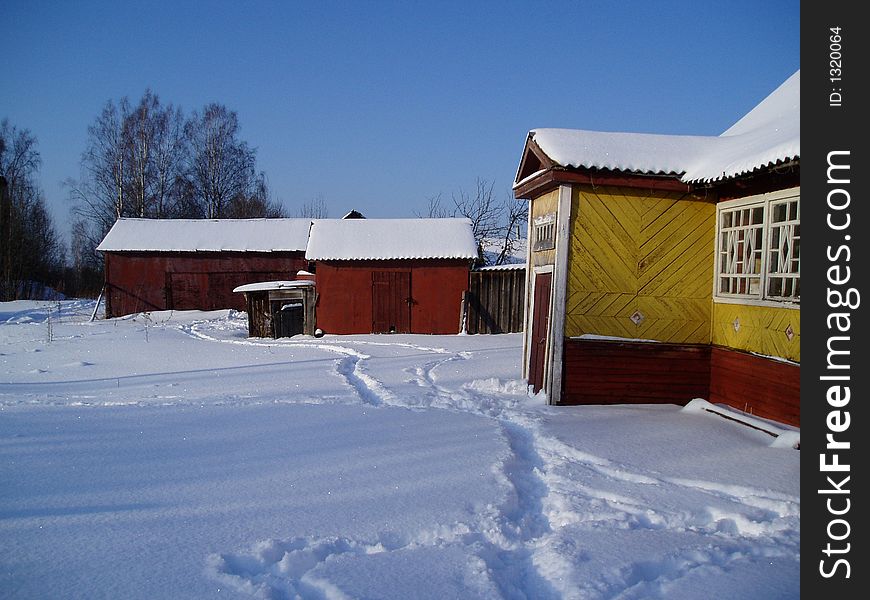 The rural farmstead in a snow, winter, Russia