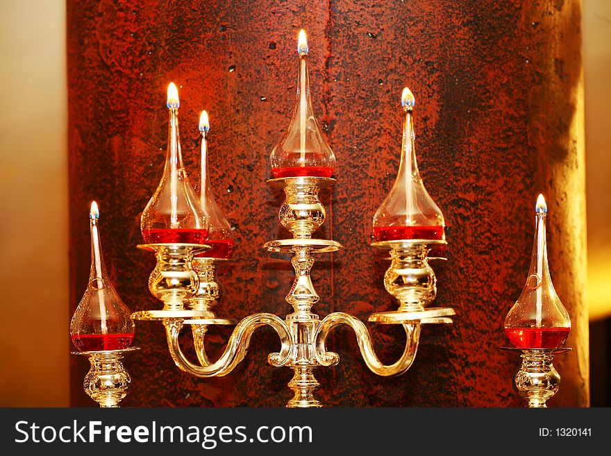 Glass lanterns on silver candleholder. Glass lanterns on silver candleholder