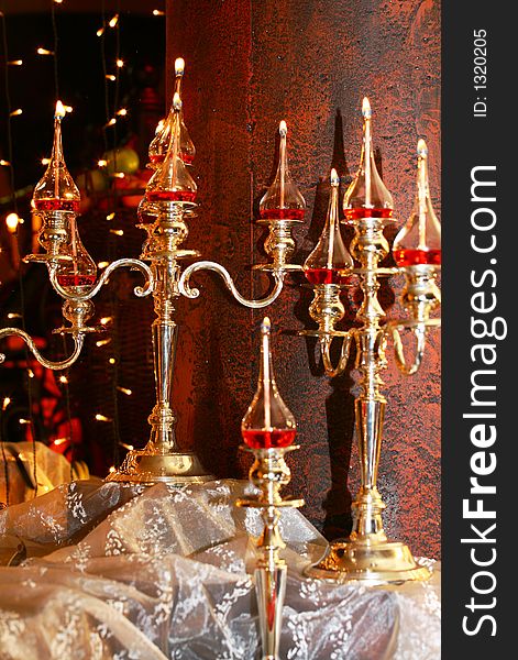 Glass lanterns on silver candleholders. Glass lanterns on silver candleholders