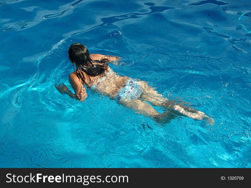 Active girl swimming in pool