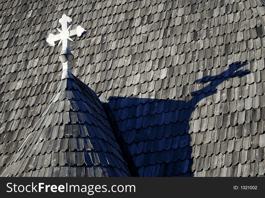 Wooden church roof with white cross