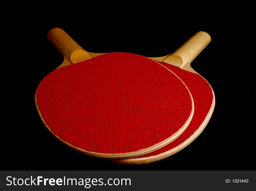 Red wooden Ping Pong Paddles isolation on black