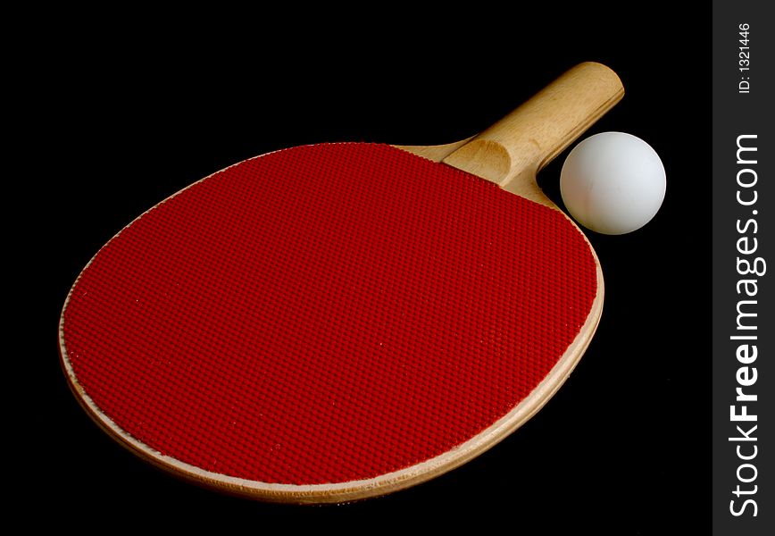 Red wooden Ping Pong Padde and ball isolation on black