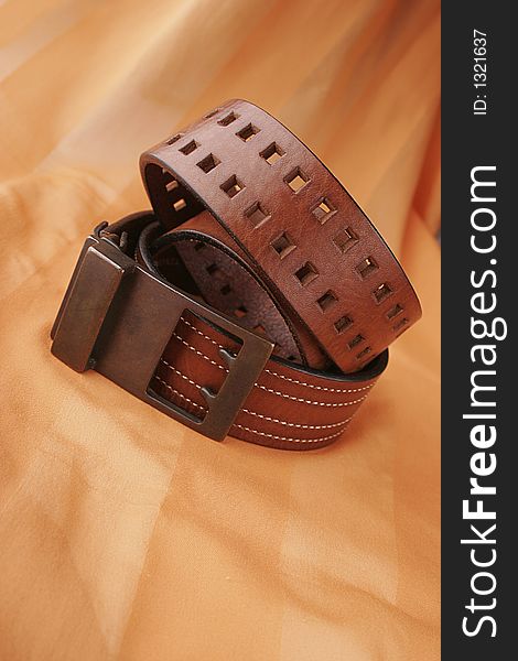 Leather belt in orange background. Leather belt in orange background