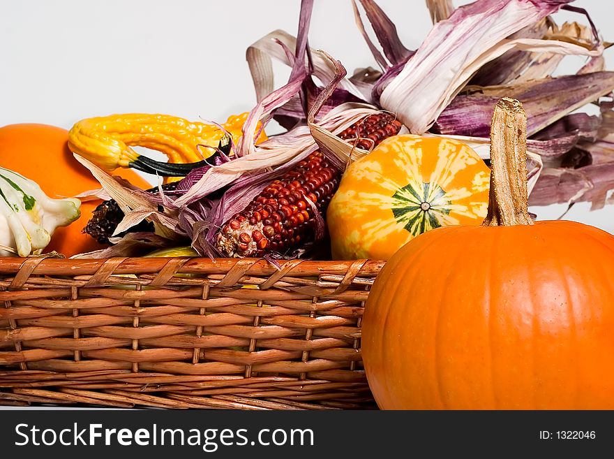 Twigs basket full of pumpkins and corn ready for Halloween. Twigs basket full of pumpkins and corn ready for Halloween