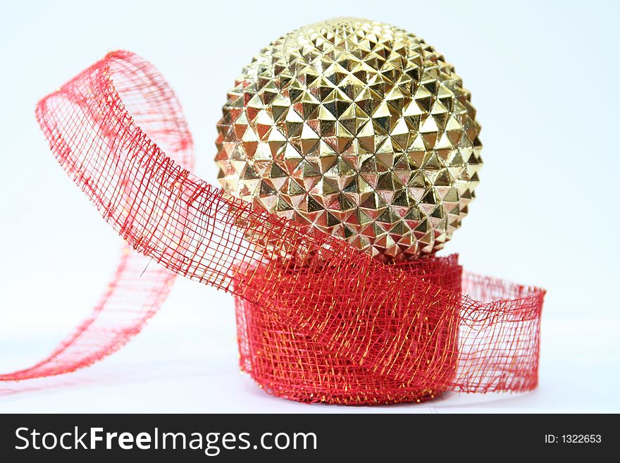 Gold ornament on red ribbon white background. Gold ornament on red ribbon white background