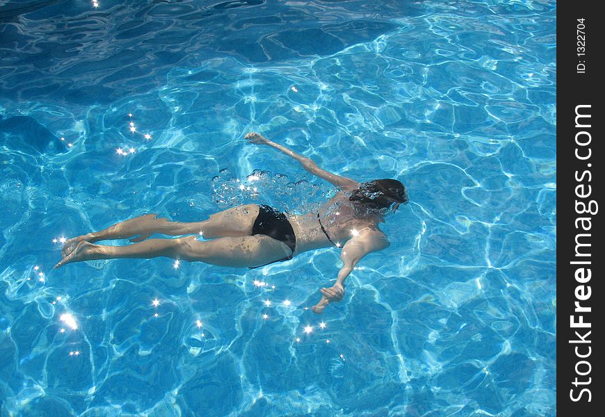 Girl swimming in clear water