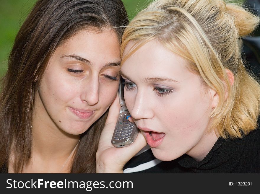 Friends on Cell Phone together (Beautiful Young Blonde and Brune