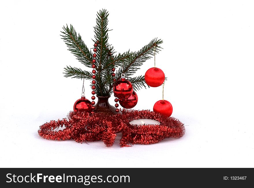 Pine branch with Christmas ornaments isolated on a white background. Pine branch with Christmas ornaments isolated on a white background