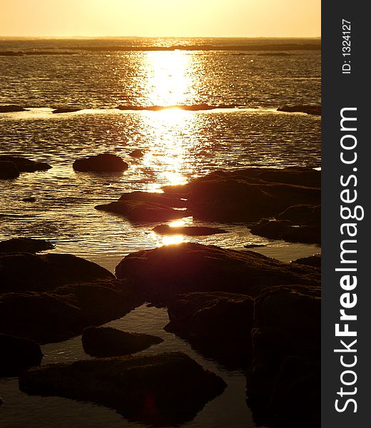 Sunset over the sea stones