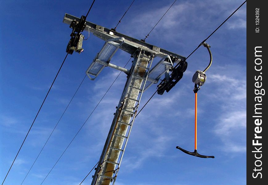 Lonely ski lift under a deep blue sky