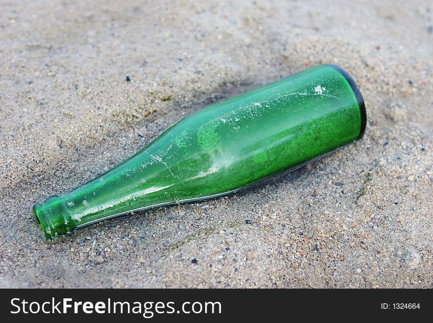 Green bottle washed up on the beach