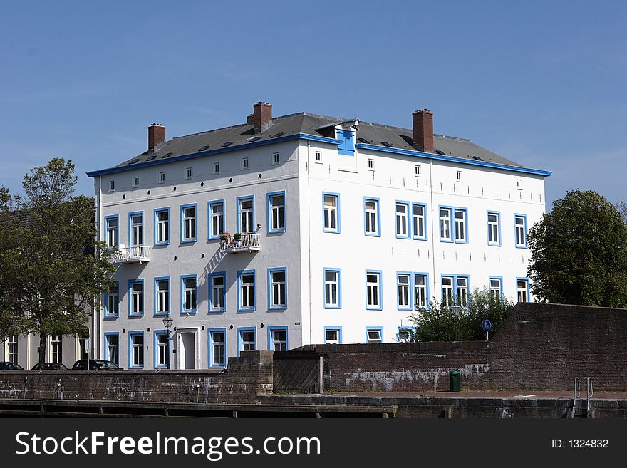 White house in Holland with blue windows