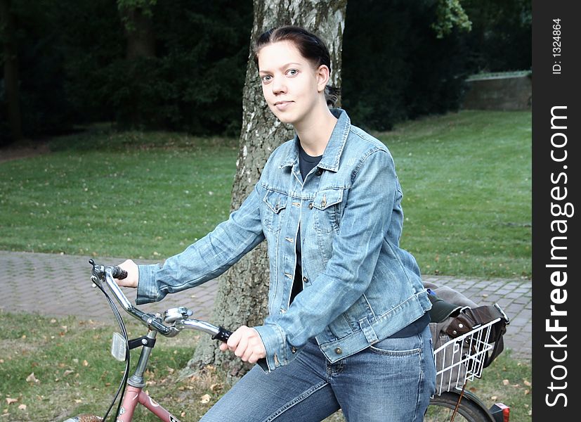 Young woman with a bicycle in the forest. Young woman with a bicycle in the forest