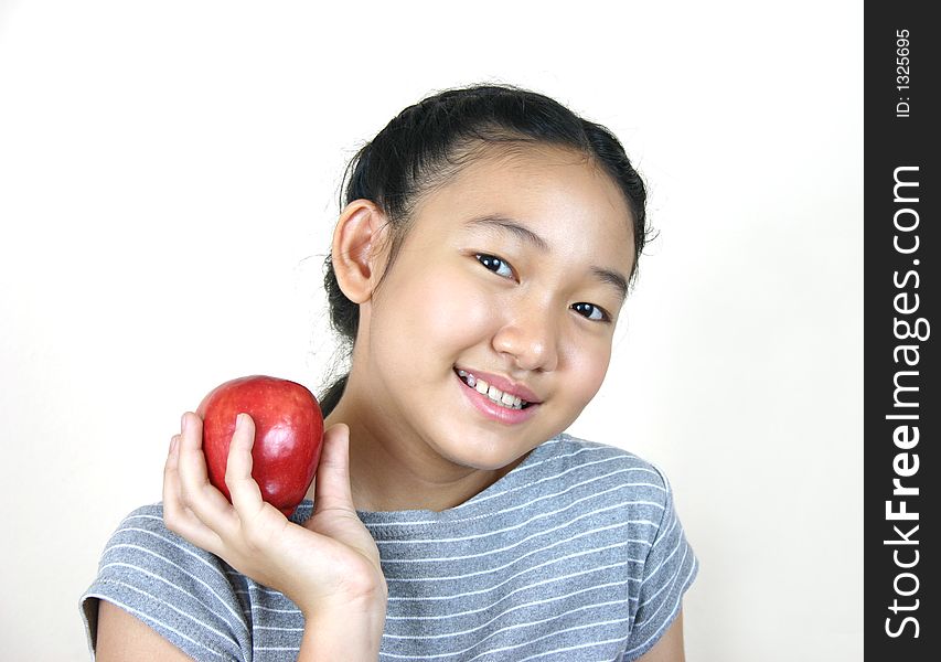 Portrait of young smart girl holding apple. Portrait of young smart girl holding apple.