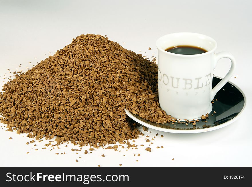Scattered instant coffee and cup of coffee