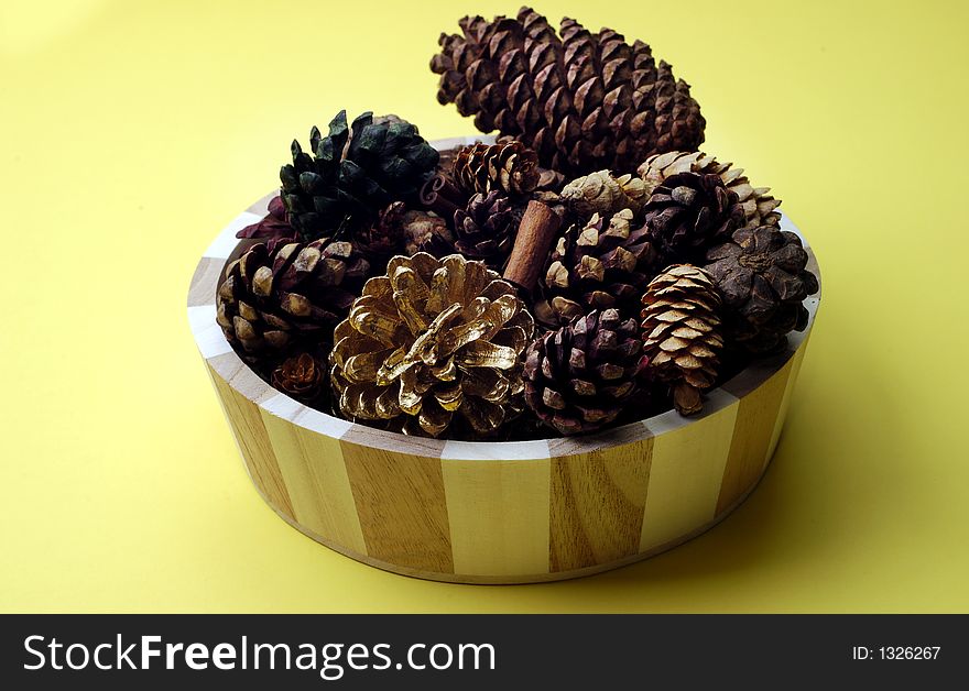 Wooden bowl full of scented pinecones. Wooden bowl full of scented pinecones
