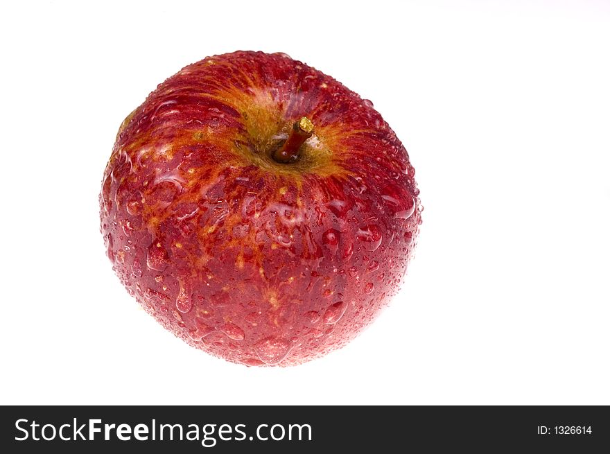 Red and wet apple on white. Red and wet apple on white