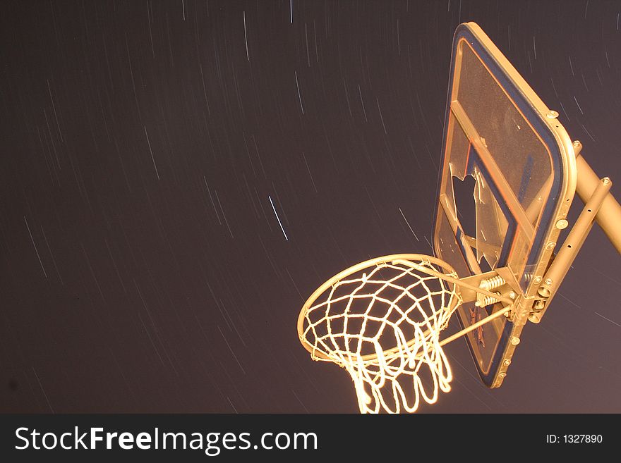 Long exposure of star trails with a bsketball hoop in the foreground