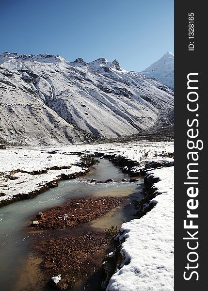 Snowcovered grassland and river in morning for mountain. Snowcovered grassland and river in morning for mountain