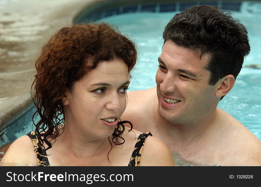 Good looking couple having good time in the pool. Good looking couple having good time in the pool