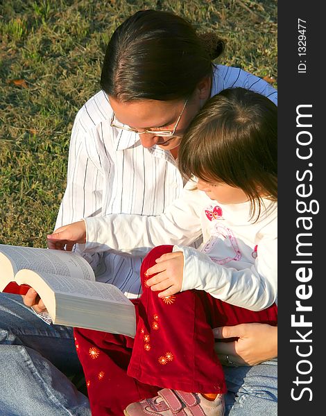 Digital photo of a mother and her daughter reading a book. Digital photo of a mother and her daughter reading a book.