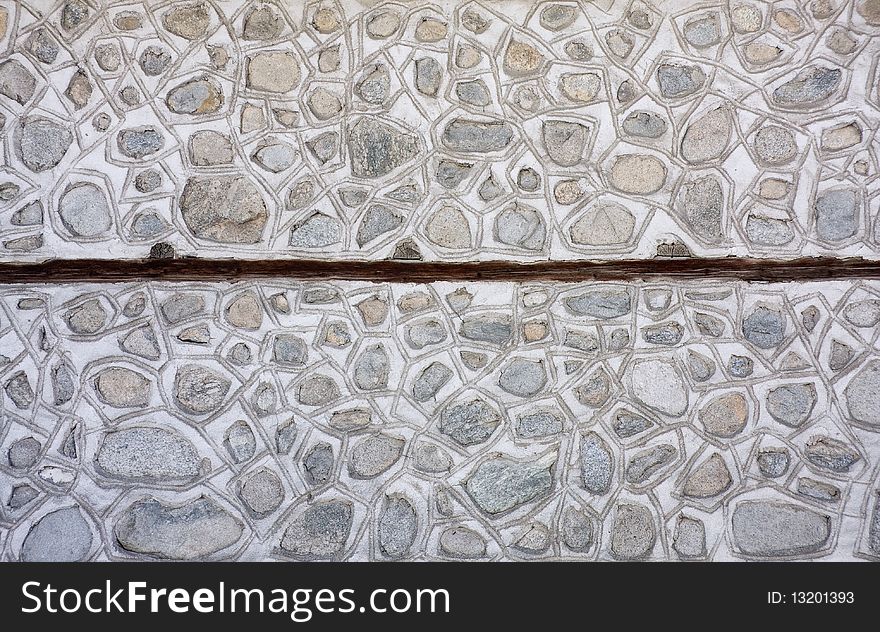 Mosaic stone wall texture background in traditional rural style. Mosaic stone wall texture background in traditional rural style