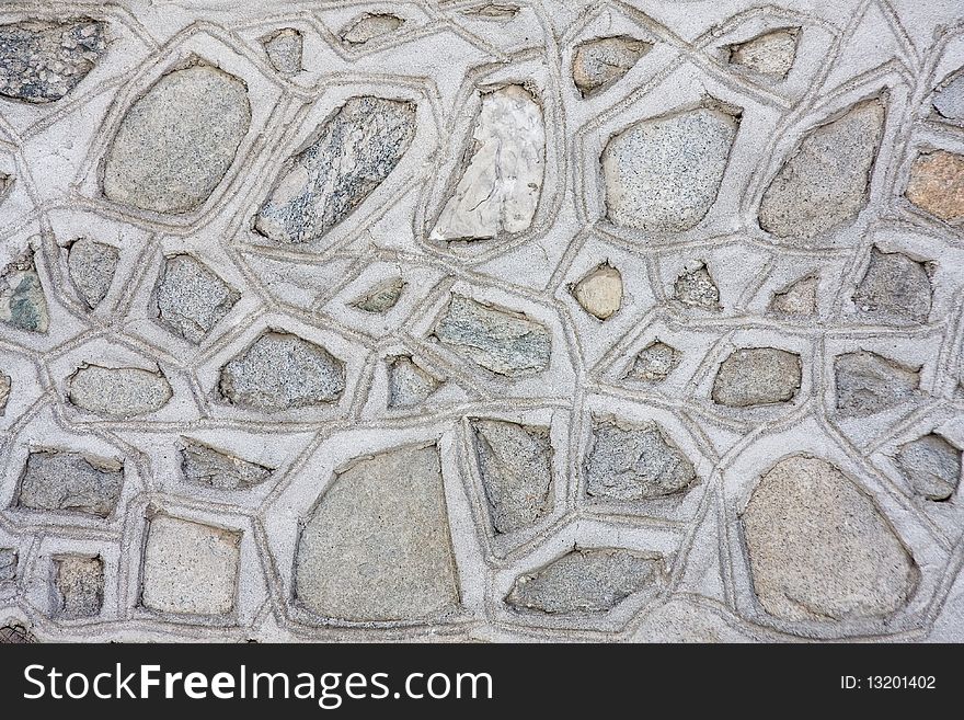 Mosaic stone wall texture background in traditional rural style. Mosaic stone wall texture background in traditional rural style