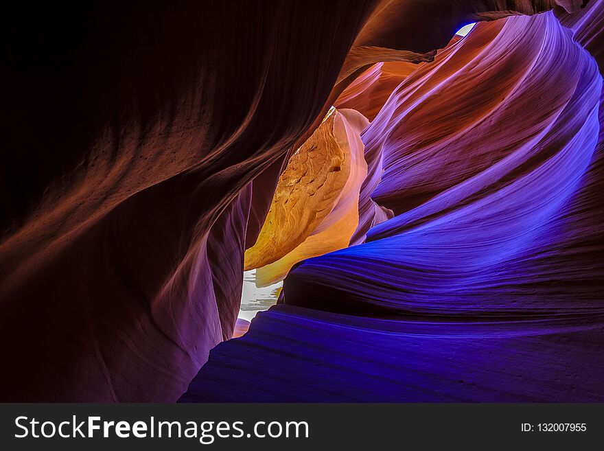 Wonders of nature formed by wind and water. Colorful curved orange, blue and purple walls in Antelope Canyon in the Navajo Reservation near Page, Arizona, USA. Wonders of nature formed by wind and water. Colorful curved orange, blue and purple walls in Antelope Canyon in the Navajo Reservation near Page, Arizona, USA.