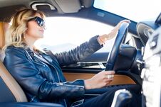 Photo Of Side Of Blonde In Black Glasses Sitting In Car Stock Photo
